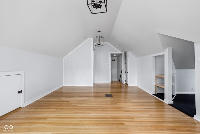 additional living space with light wood-type flooring and lofted ceiling