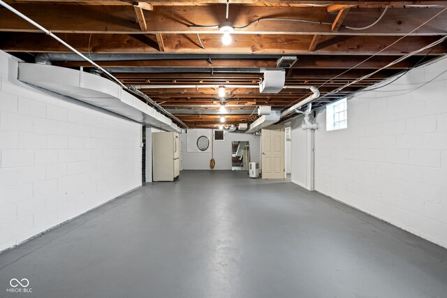 basement featuring white fridge