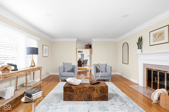 living room featuring crown molding and light hardwood / wood-style floors