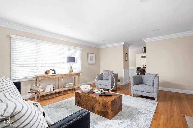 living room with ornamental molding and light hardwood / wood-style flooring