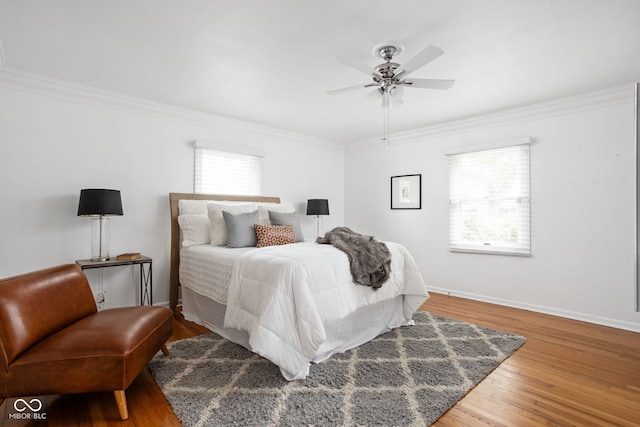 bedroom with ornamental molding, wood-type flooring, and ceiling fan