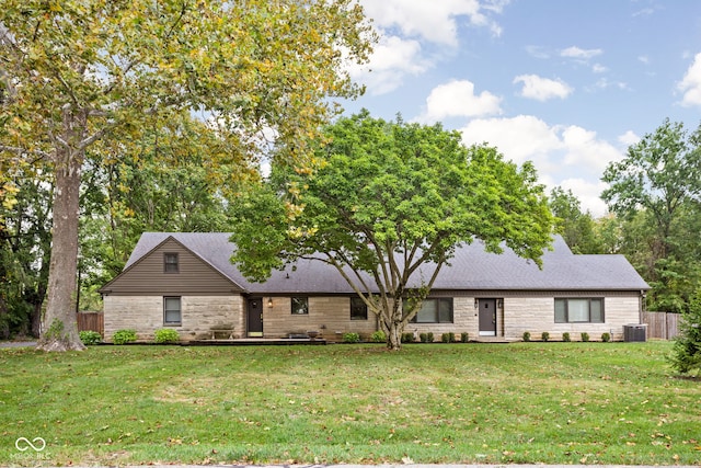 single story home with a front yard and central AC unit