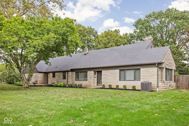 view of front of property featuring central AC unit and a front yard