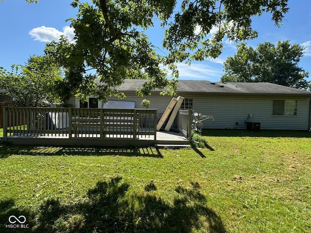 back of house featuring a yard, central AC, and a deck