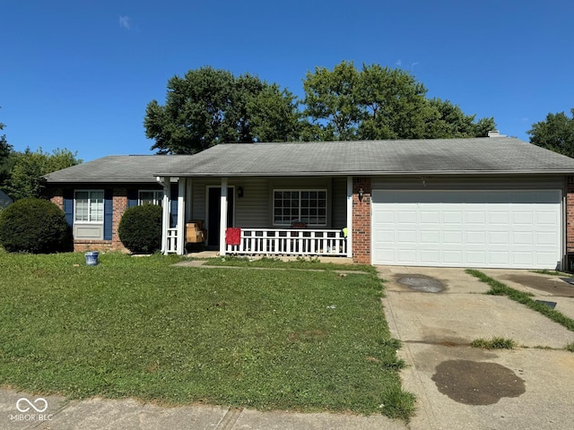 ranch-style house featuring a garage, covered porch, and a front lawn