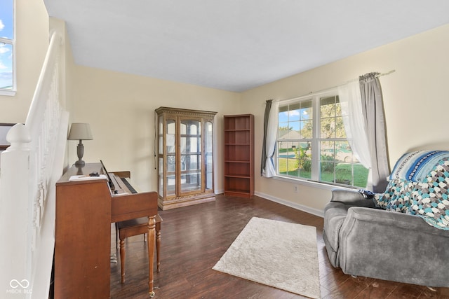 sitting room featuring dark wood-style flooring and baseboards