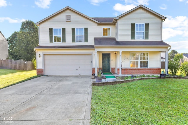 front of property with covered porch, a garage, and a front yard