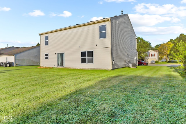 rear view of property with a lawn