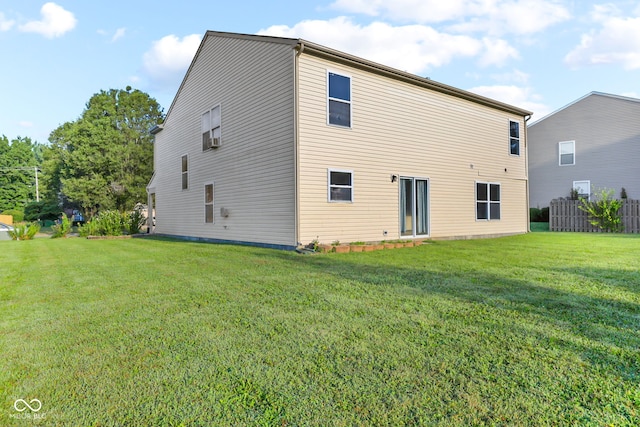 back of house with a lawn