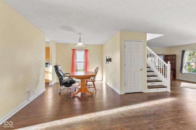 dining space with dark wood-type flooring, stairway, and baseboards