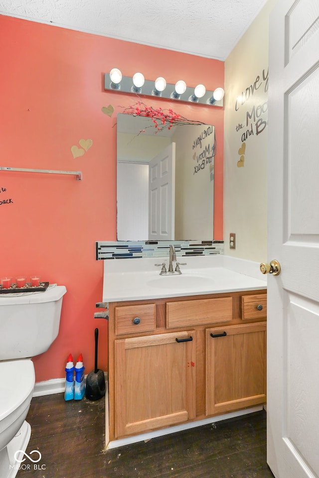 bathroom with wood-type flooring, vanity, and toilet