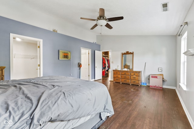 bedroom featuring ceiling fan, a spacious closet, dark hardwood / wood-style floors, and lofted ceiling