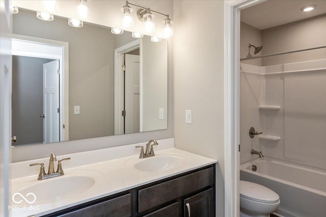 full bathroom featuring shower / bathing tub combination, vanity, and toilet