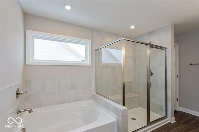 bathroom featuring hardwood / wood-style floors and separate shower and tub