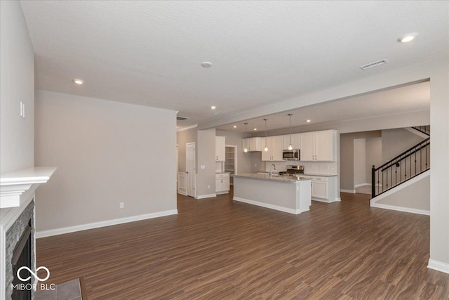 unfurnished living room with a premium fireplace and dark hardwood / wood-style flooring