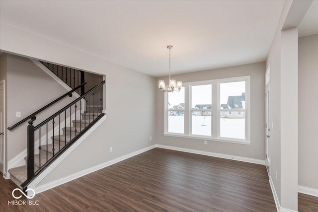 interior space featuring a notable chandelier and dark hardwood / wood-style flooring