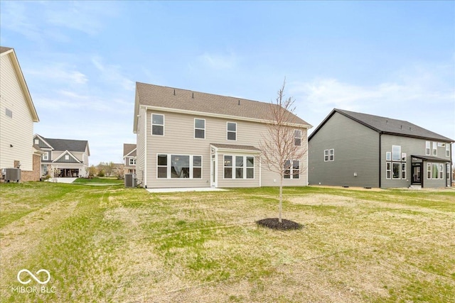 back of house featuring a lawn and central AC unit