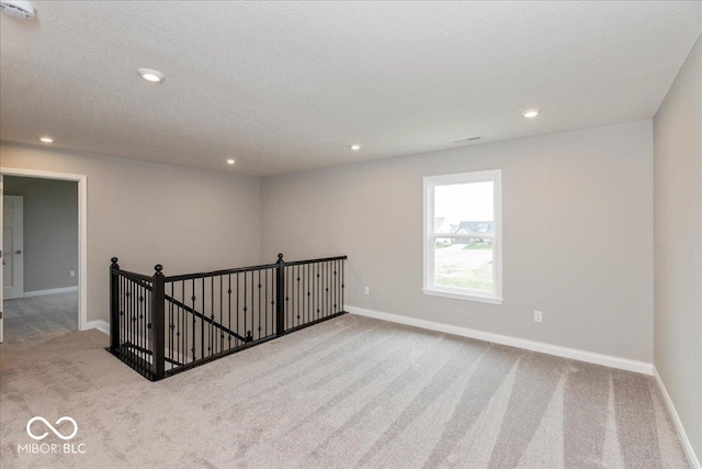 unfurnished room featuring recessed lighting, carpet floors, and baseboards