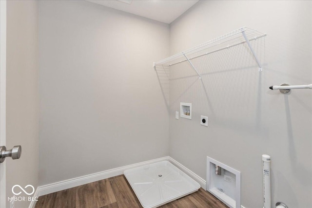 washroom with wood finished floors, hookup for a washing machine, baseboards, and laundry area