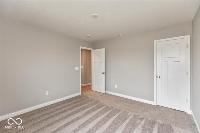 interior space with baseboards and carpet