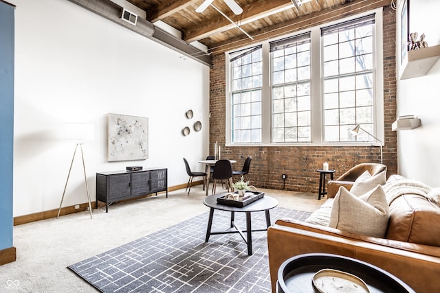 carpeted living room featuring brick wall, beam ceiling, and wooden ceiling