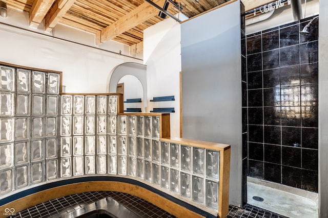 bathroom with wooden ceiling, walk in shower, beam ceiling, and tile patterned flooring