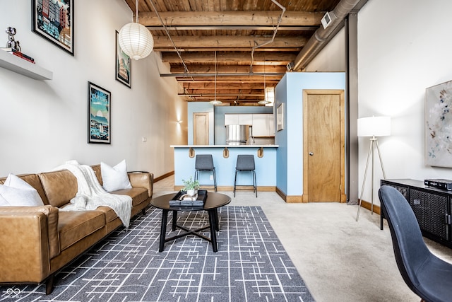 carpeted living room with beamed ceiling and wooden ceiling