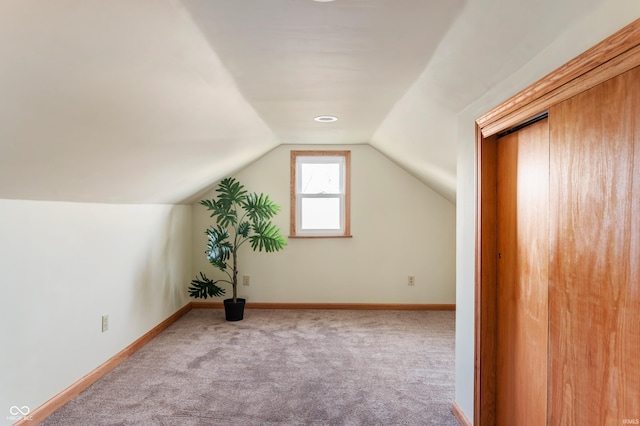 bonus room with vaulted ceiling, carpet flooring, and baseboards