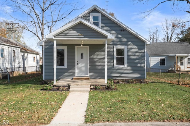 bungalow-style home with a front yard, central air condition unit, and a porch