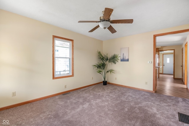 unfurnished room with ceiling fan and carpet floors