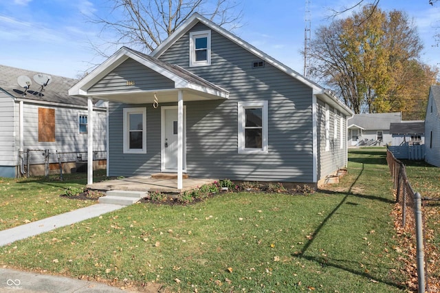 bungalow-style house featuring fence and a front yard