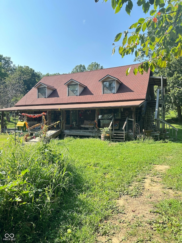 rear view of property with a yard