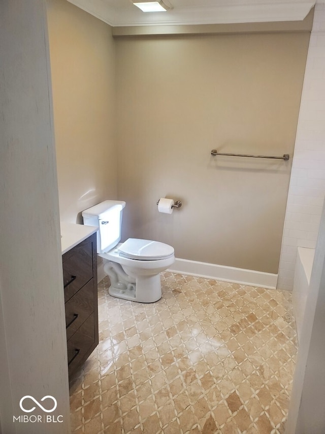 bathroom with a washtub, baseboards, toilet, tile patterned floors, and vanity