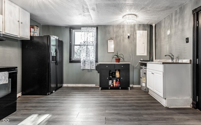 bar featuring white cabinets, a textured ceiling, dark hardwood / wood-style flooring, and black appliances