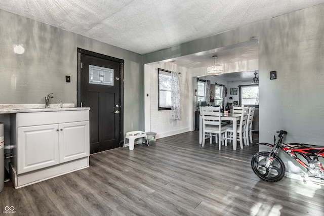 interior space with hardwood / wood-style floors, sink, and a textured ceiling