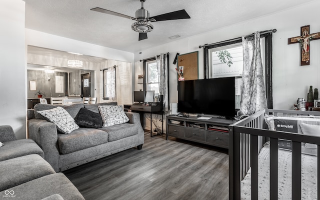 living room featuring a textured ceiling, ceiling fan, and hardwood / wood-style floors