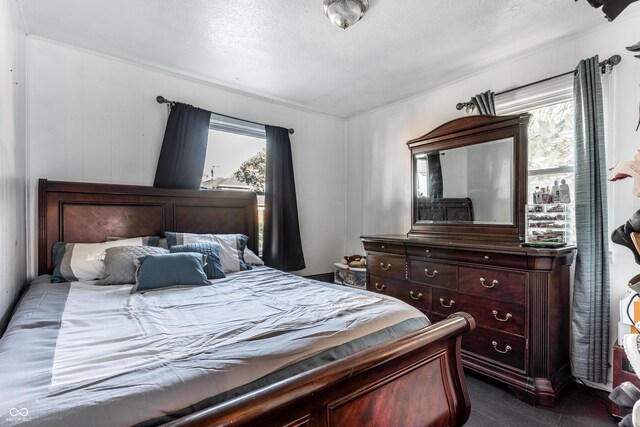 bedroom featuring multiple windows and a textured ceiling