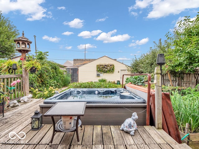 wooden deck with an outdoor hot tub