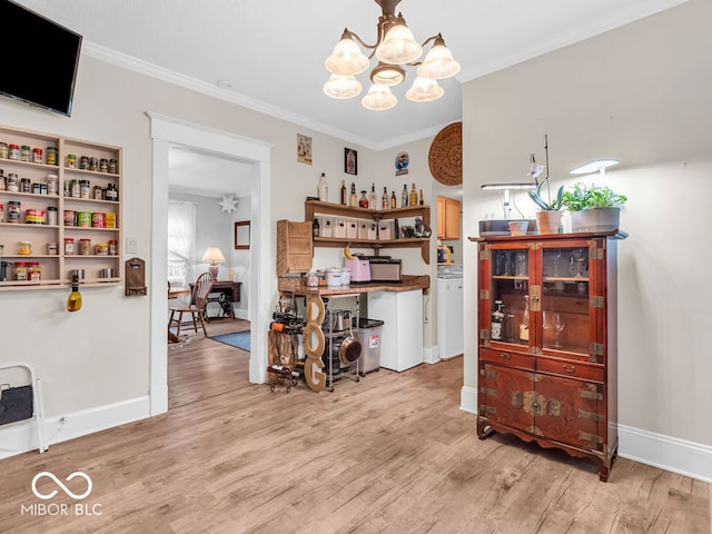 dining area featuring light hardwood / wood-style floors, ornamental molding, and a chandelier