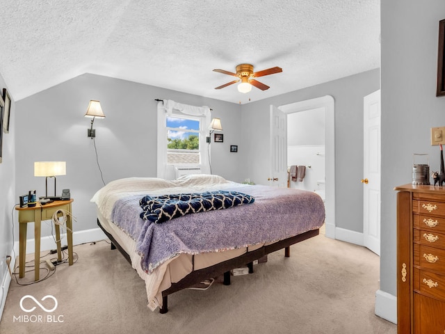 bedroom featuring ceiling fan, vaulted ceiling, a textured ceiling, and light carpet