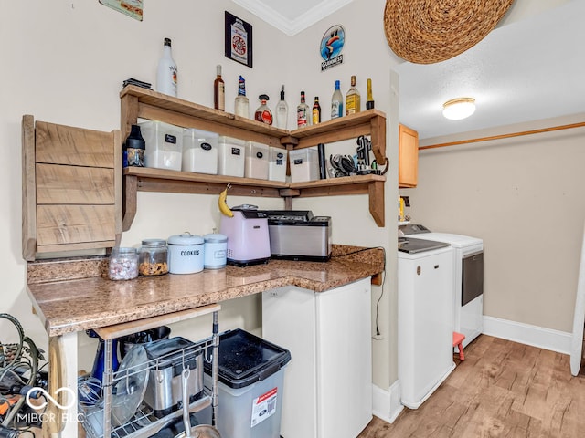 kitchen featuring light hardwood / wood-style floors, independent washer and dryer, and ornamental molding