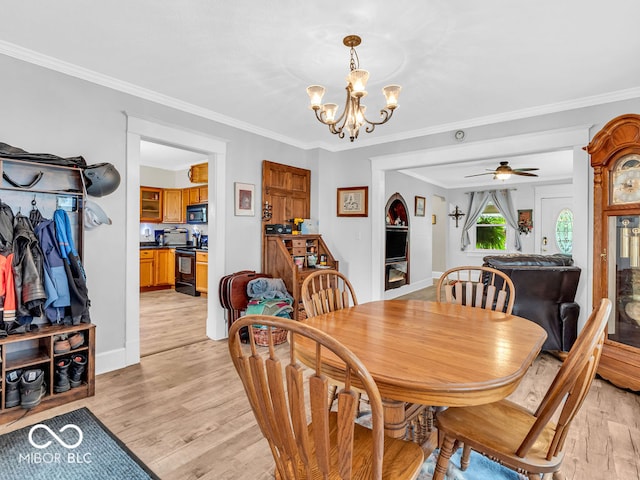 dining space featuring light hardwood / wood-style flooring, ceiling fan with notable chandelier, and ornamental molding