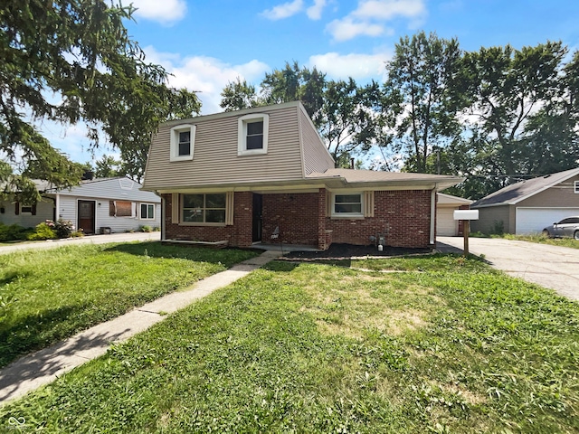 view of front of home with a front yard and a garage