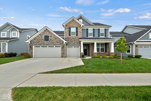 craftsman-style home featuring a garage and a front yard