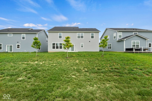 rear view of property featuring a yard