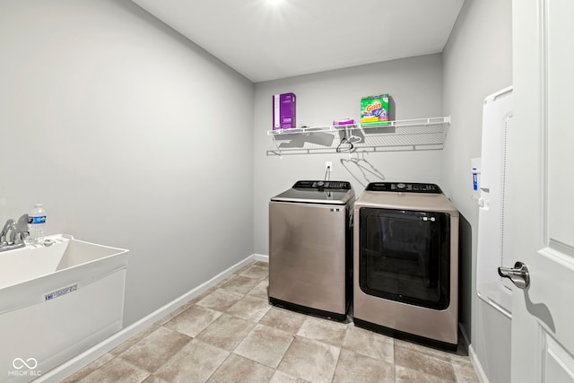 washroom with light tile patterned floors and washer and clothes dryer