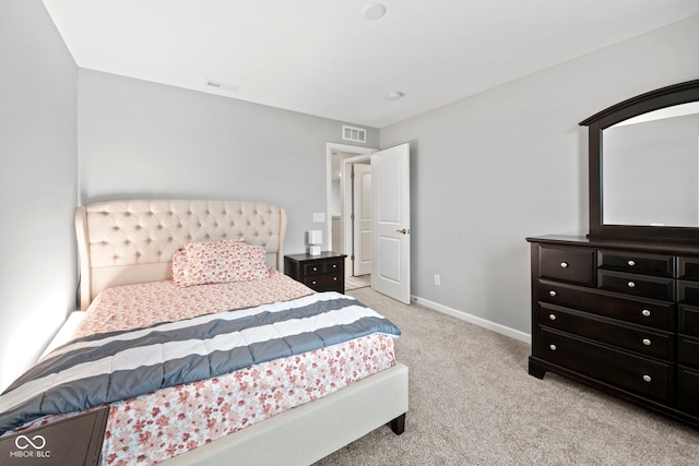 bedroom with light colored carpet