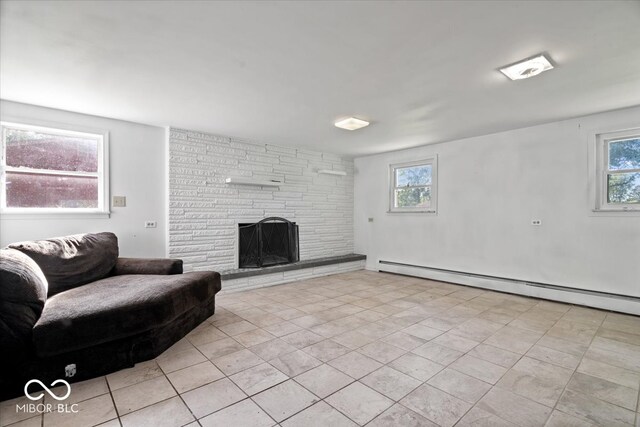 living room featuring a fireplace, a wealth of natural light, and a baseboard radiator