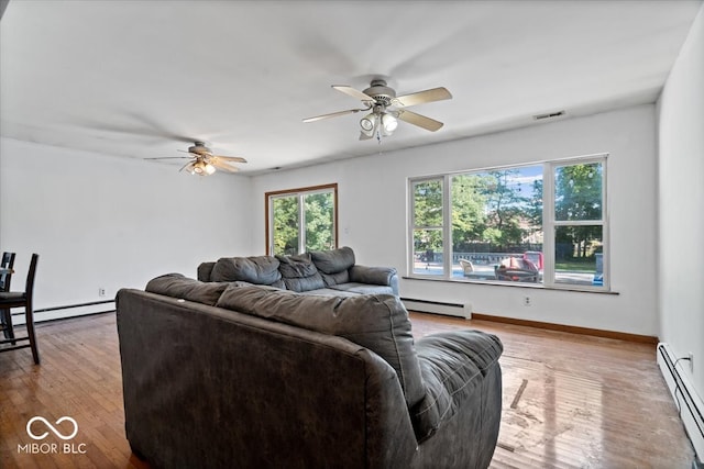 living room with ceiling fan, baseboard heating, and light hardwood / wood-style floors