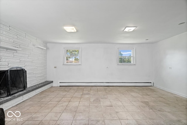 basement featuring a fireplace, baseboard heating, and a healthy amount of sunlight